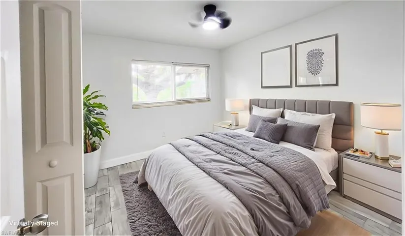 Bedroom with wood finish floors and baseboards