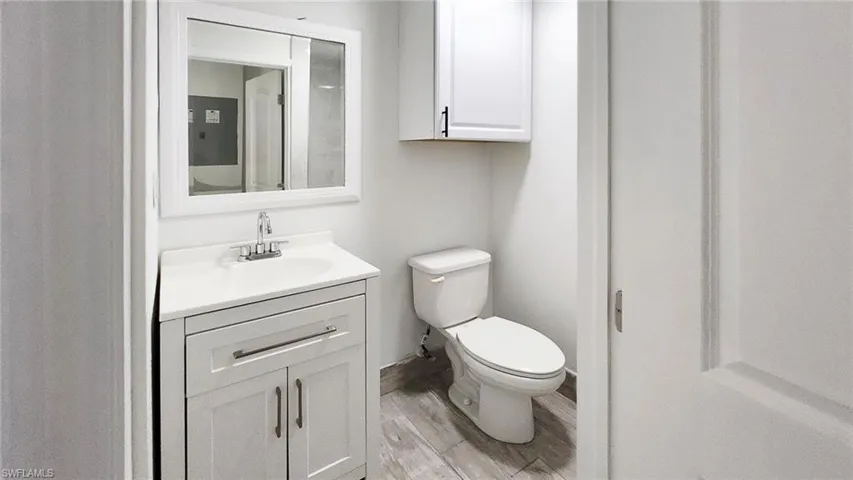 Bathroom with vanity and wood finish floors