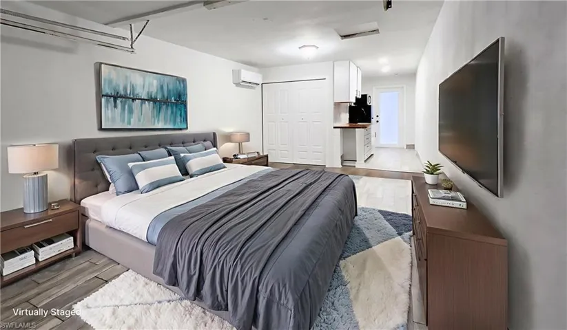 Bedroom featuring wood finished floors and a closet