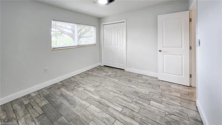 Unfurnished bedroom featuring light wood finished floors and a closet