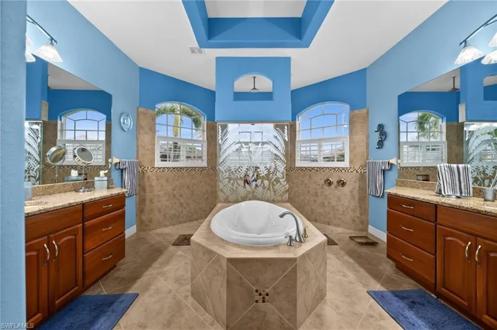 Master bath has ouble vanities and walk-through shower