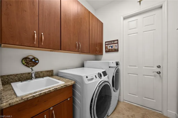 Large laundry room leads to the six-car garage