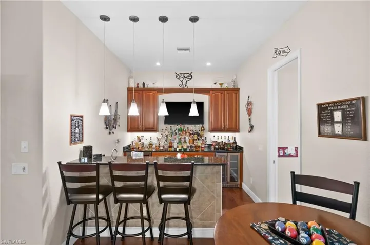 Full bar with two beverage coolers and automatic liquor dispenser