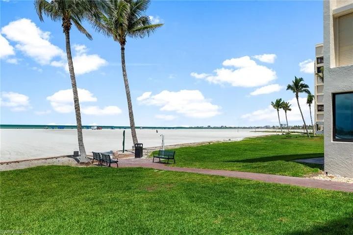 View of green lawn featuring a water view