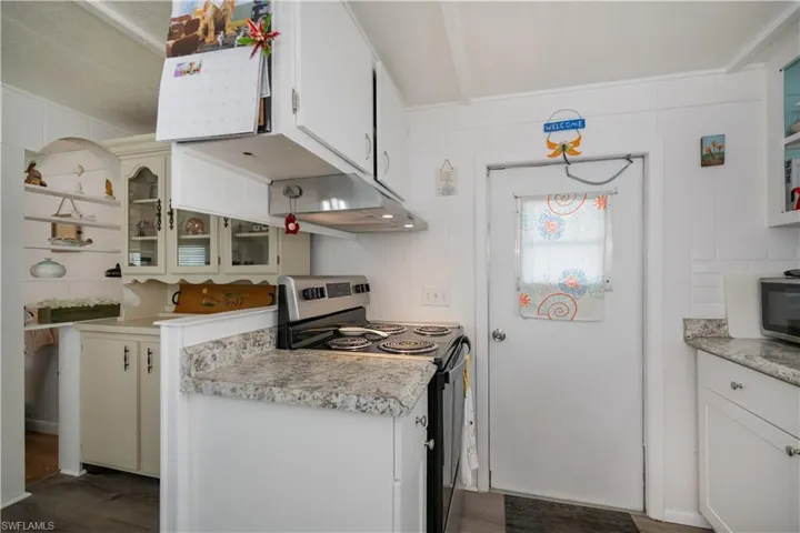 Kitchen with white cabinets and stainless steel electric range oven