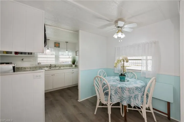 Dining area featuring dark hardwood / wood-style floors, ceiling fan, and sink
