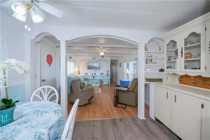 Dining space featuring beamed ceiling, ceiling fan, and light hardwood / wood-style flooring