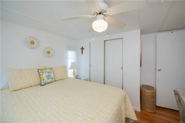 Bedroom with a closet, hardwood / wood-style flooring, and ceiling fan