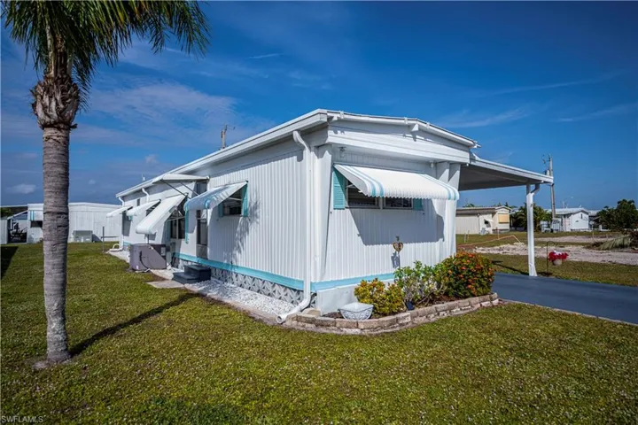 View of property exterior featuring a lawn