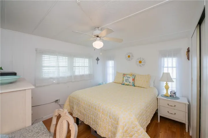 Bedroom featuring ceiling fan and wood-type flooring