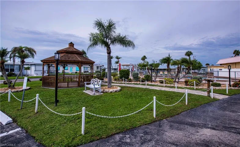 View of property's community with a gazebo and a lawn