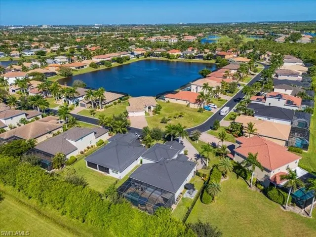 Aerial perspective showcasing a residential community with numerous properties featuring varied architectural styles and roofing materials