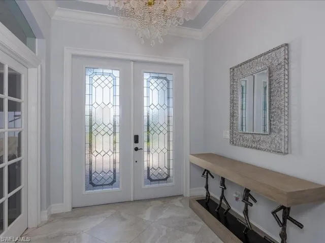 Double entry doors with decorative etched glass panels