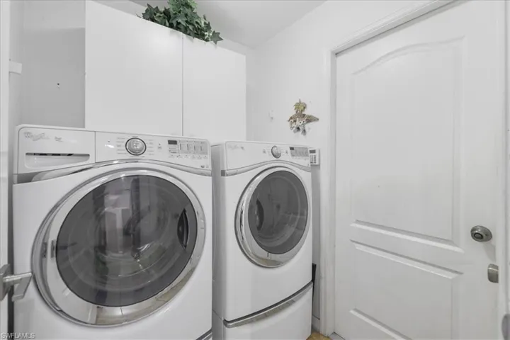 Laundry room with washer and clothes dryer and laundry area