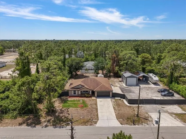 Drone / aerial view with a wooded view