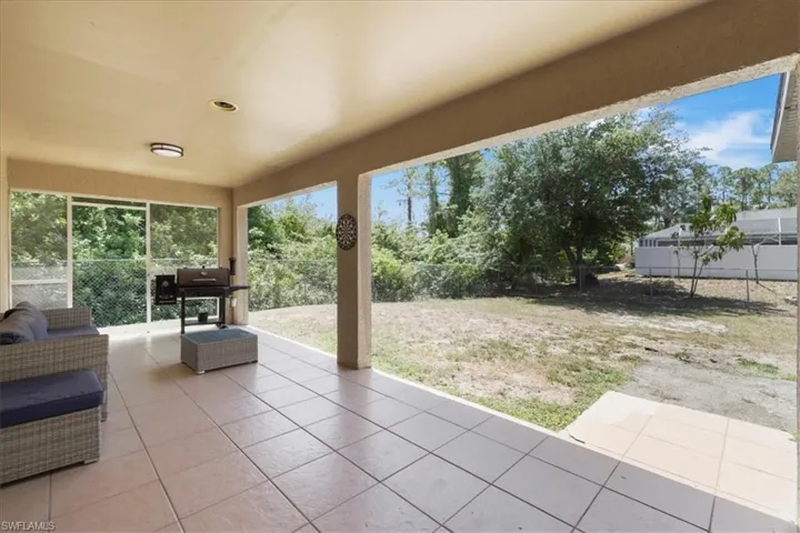 View of patio / terrace with grilling area and a fenced backyard