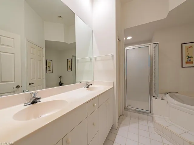 Bathroom featuring a sink, tile patterned floors, a shower stall, and a bath