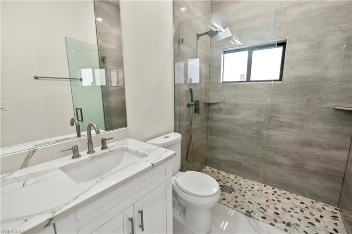 Full bathroom featuring walk in shower and vanity