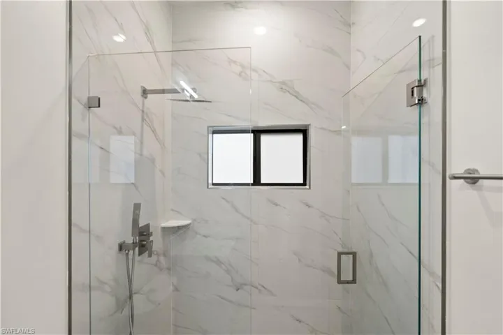 Bathroom featuring a marble finish shower