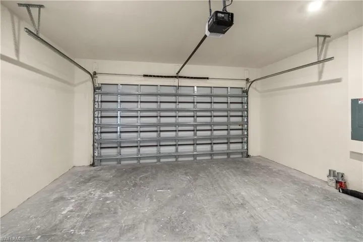 Garage with a garage door opener and electric panel