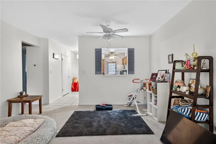 Sitting room with light carpet and ceiling fan