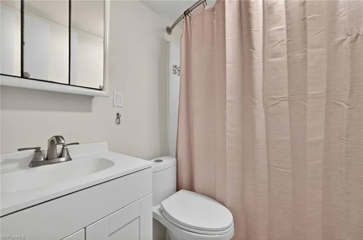 Full bath with vanity and curtained shower