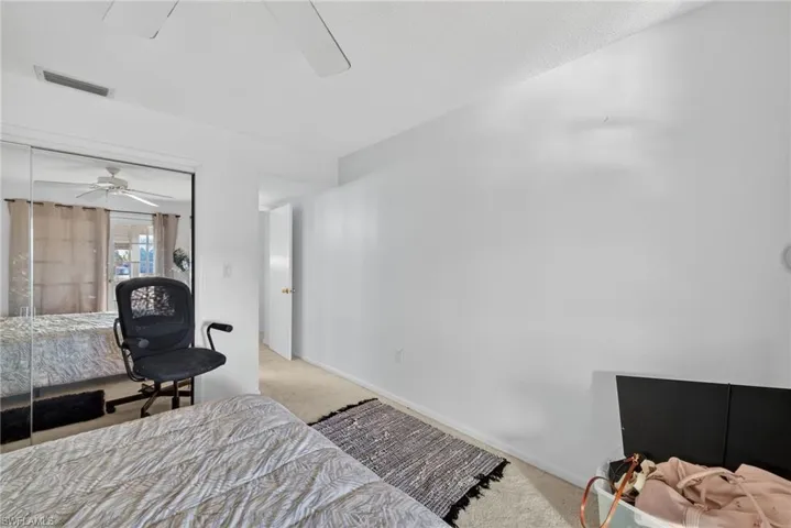 Bedroom with carpet floors, a closet, and ceiling fan