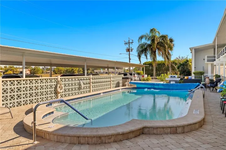 Community pool with a patio