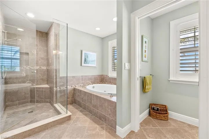 Bathroom featuring a shower stall, a bath, light tile patterned floors, and recessed lighting