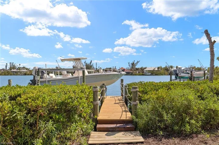 Dock featuring boat lift and a water view