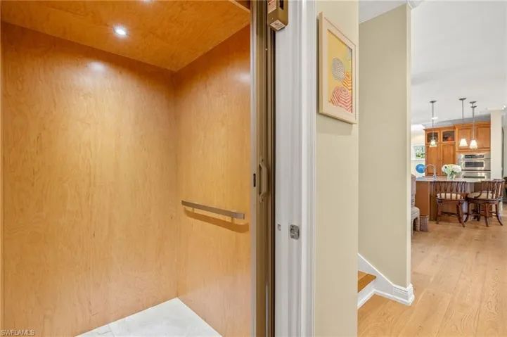 Elevator with wood finished floors and recessed lighting