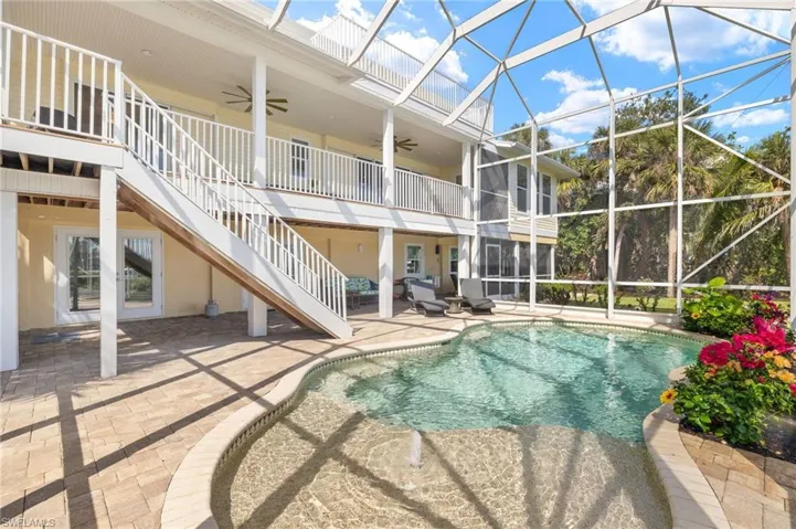 Swimming pool with stairway, a patio area, ceiling fan, a sunroom, and a lanai
