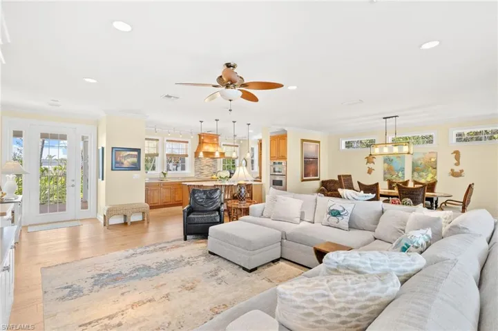 Living area featuring crown molding, light wood-type flooring, ceiling fan, and recessed lighting