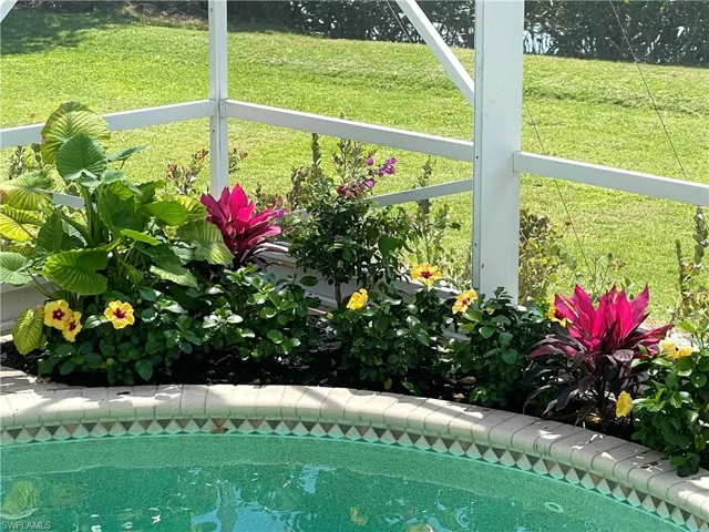 Outdoor pool featuring a lawn