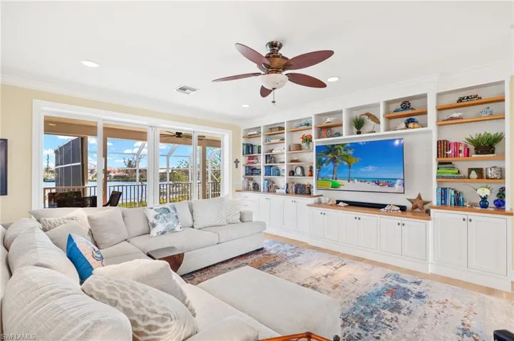 Living room featuring a ceiling fan, light wood finished floors, crown molding, and recessed lighting