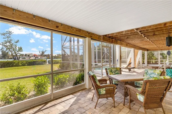 Sunroom featuring outdoor dining space