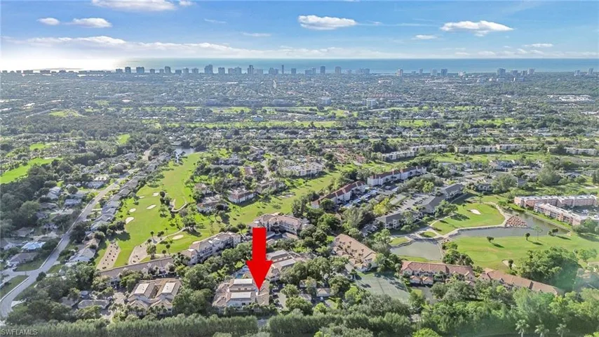 Aerial view of property's location featuring a nearby body of water and skyline