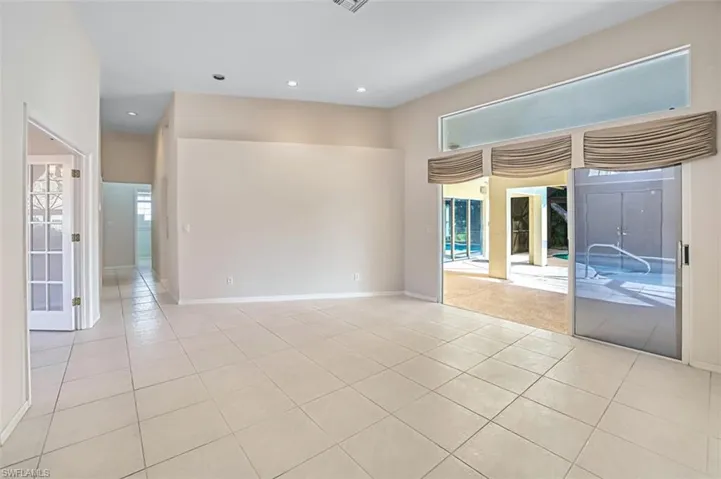 Empty room with recessed lighting and light tile patterned floors