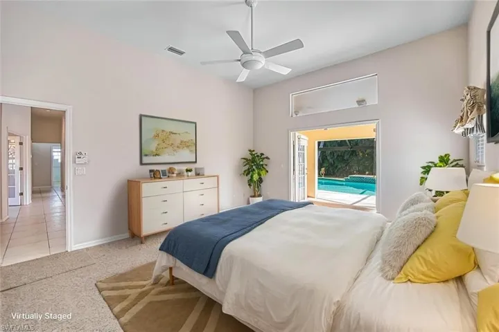 *VIRTUALLY STAGED* Bedroom with light colored carpet, access to exterior, and a ceiling fan