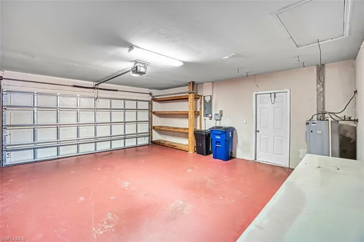 Garage with electric panel and a garage door opener
