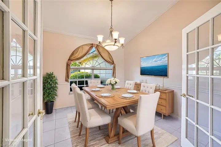 *VIRTUALLY STAGED* Den featuring light tile patterned floors, a chandelier, and crown molding