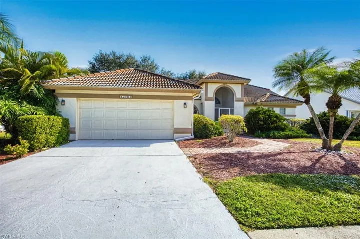 Mediterranean / spanish home featuring concrete driveway, stucco siding, a tile roof, and a garage