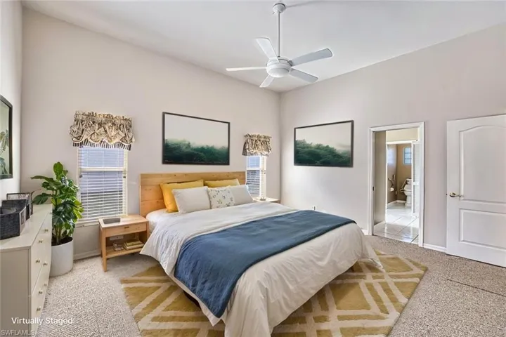 *VIRTUALLY STAGED* Carpeted bedroom featuring a ceiling fan