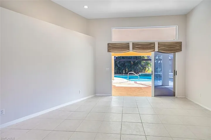 Unfurnished room with a sunroom, light tile patterned floors, and recessed lighting