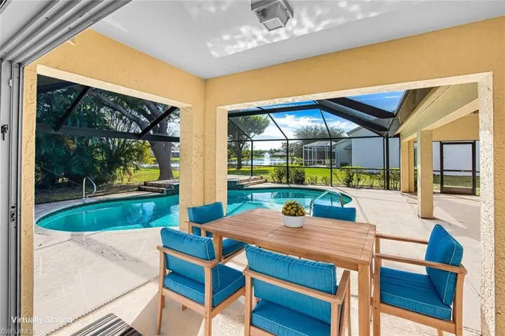 *VIRTUALLY STAGED* Swimming pool featuring a patio area, a sunroom, outdoor dining space, and glass enclosure