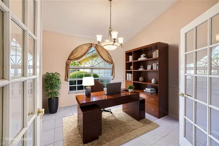 *VIRTUALLY STAGED* Home office featuring light tile patterned floors, french doors, crown molding, a chandelier, and vaulted ceiling