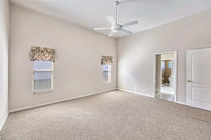Unfurnished room with light carpet and ceiling fan