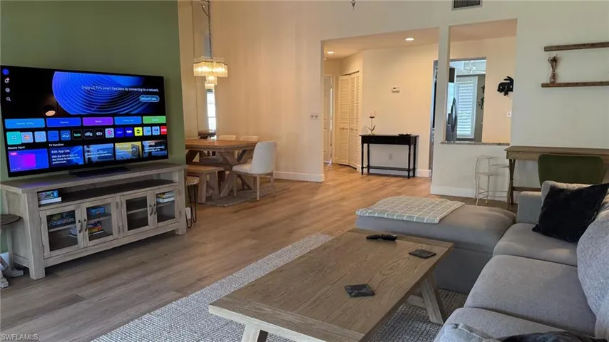 Living room featuring a chandelier and light hardwood / wood-style floors