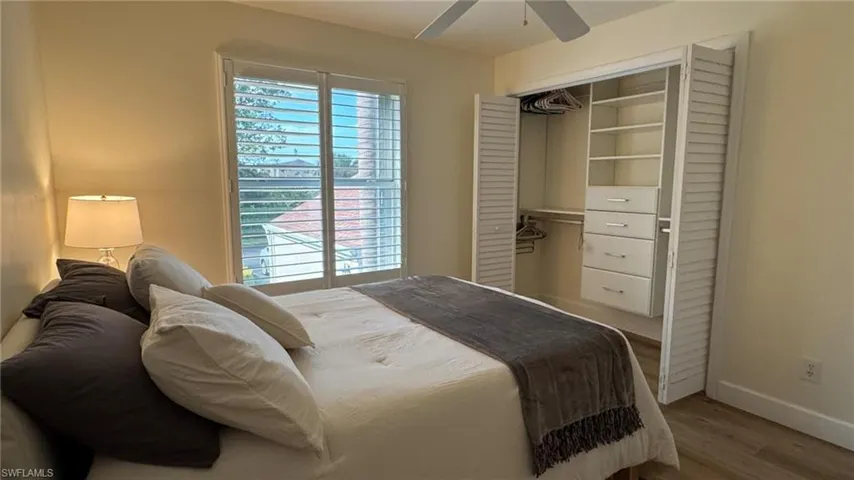 Guest Bedroom featuring ceiling fan, a closet, and wood-type flooring