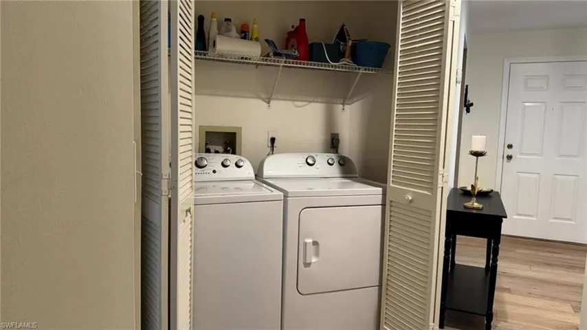 Washroom featuring light hardwood / wood-style floors and separate washer and dryer